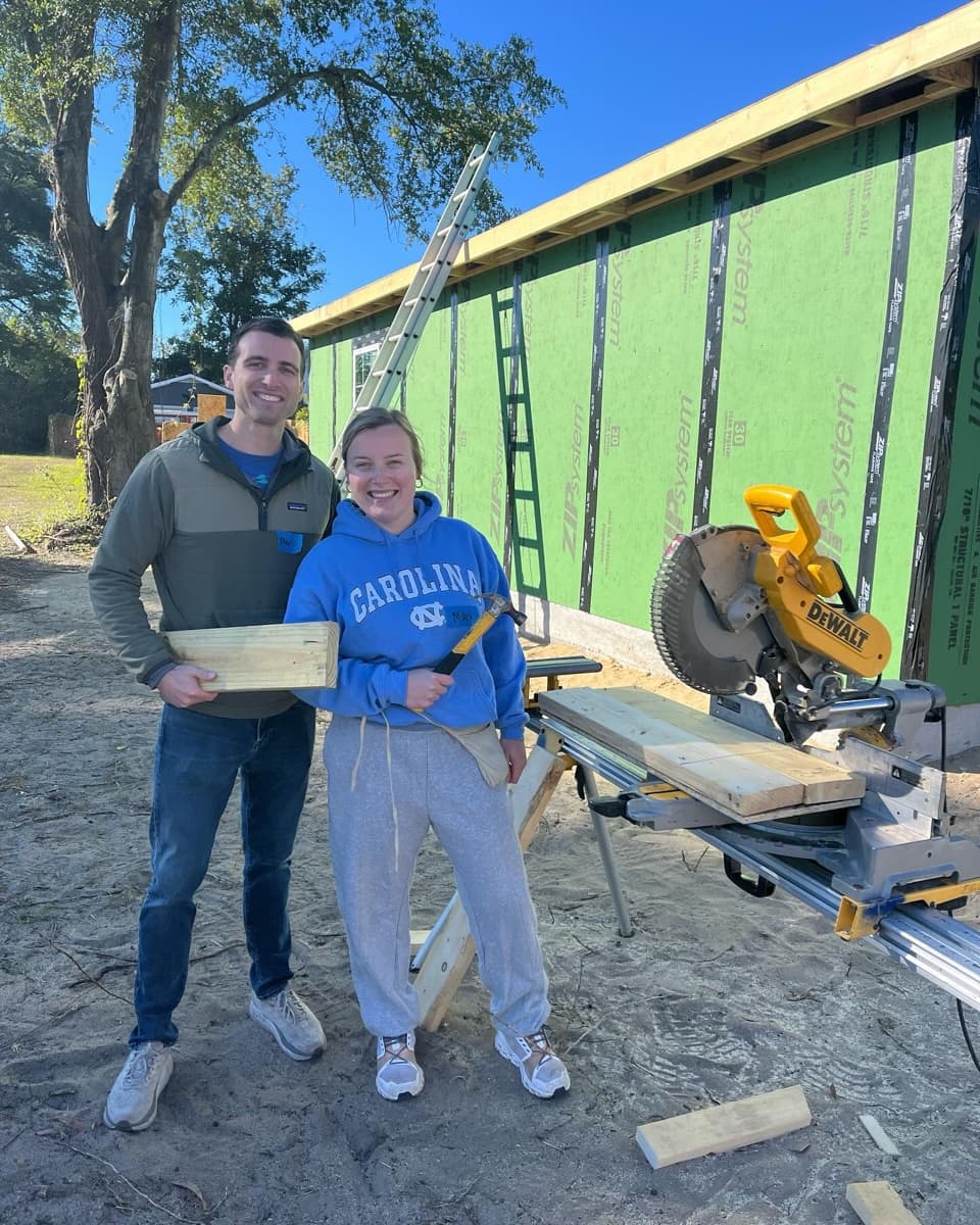 Two team members at a community house build