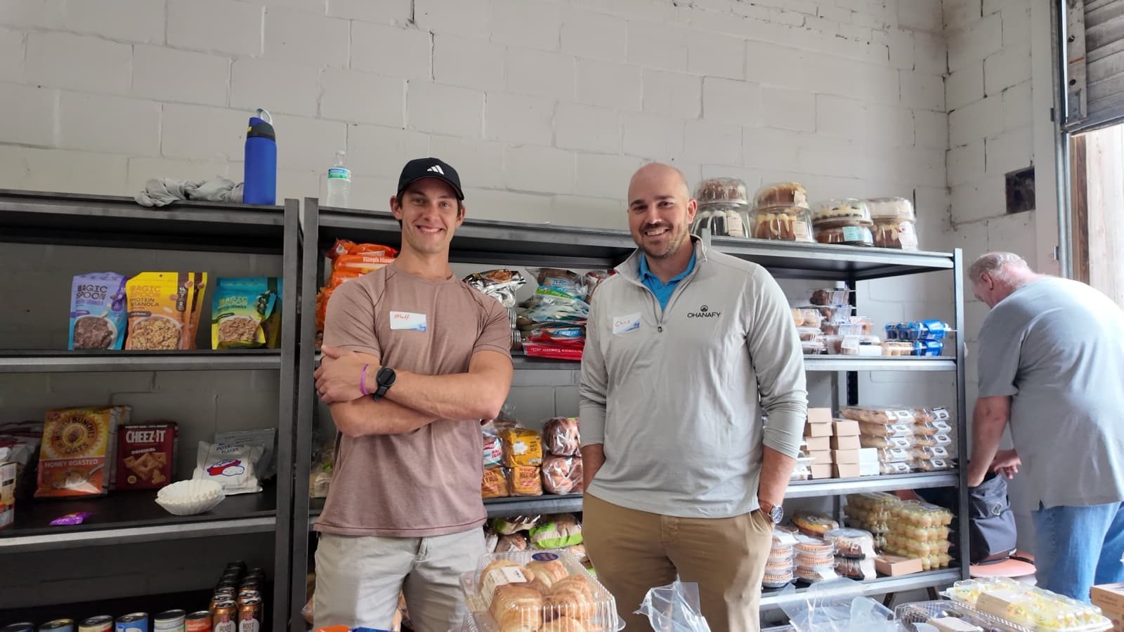 Ohanafy team stocking shelves at a community food pantry
